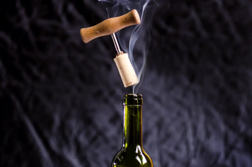 Opening a wine bottle with a corkscrew