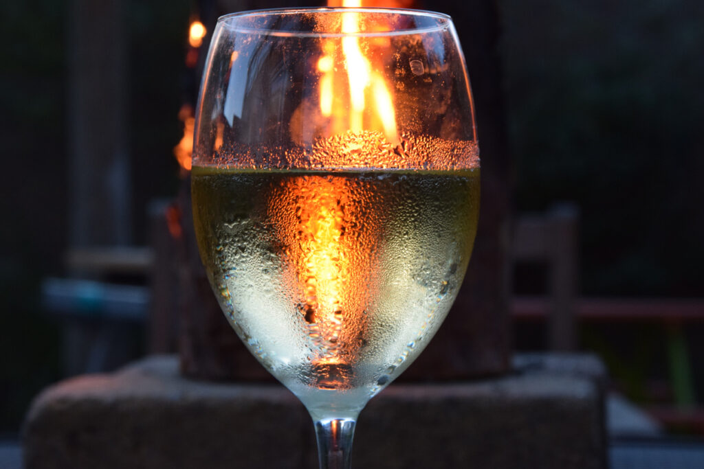 Glass of wine on a summer night with fire