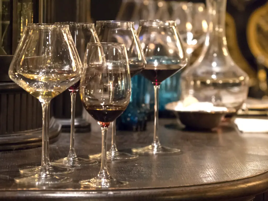 Glasses of elite wine on the bar in dark interior