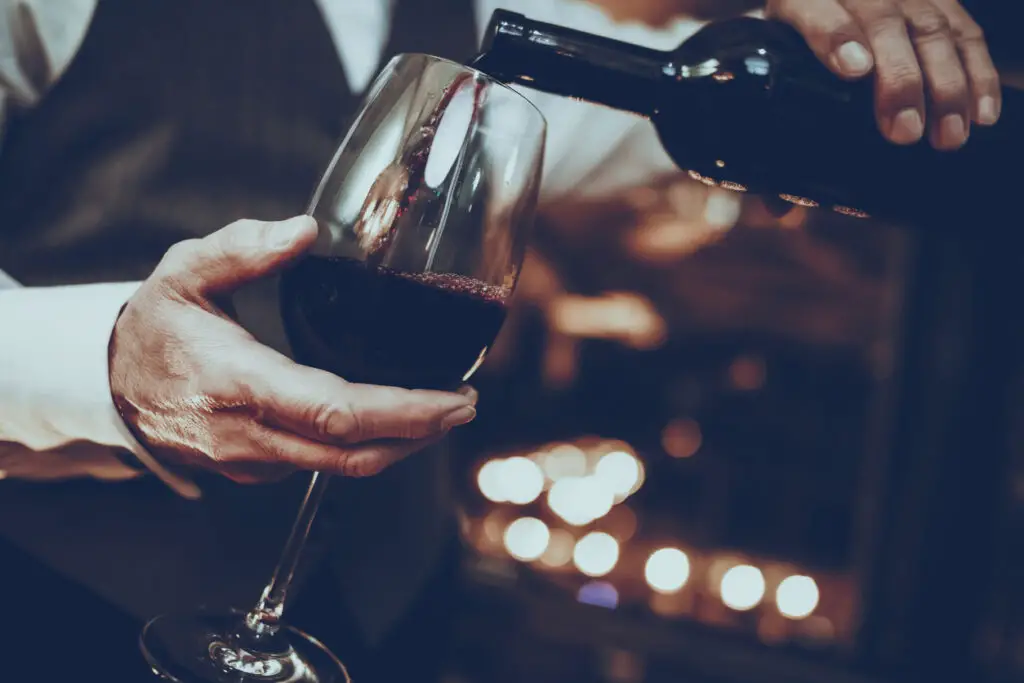 Sommelier is Pouring Wine from Bottle to Glass