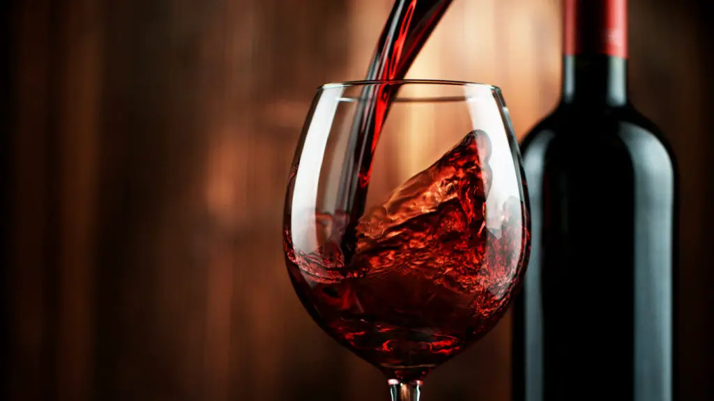 Detail of pouring red wine into glass