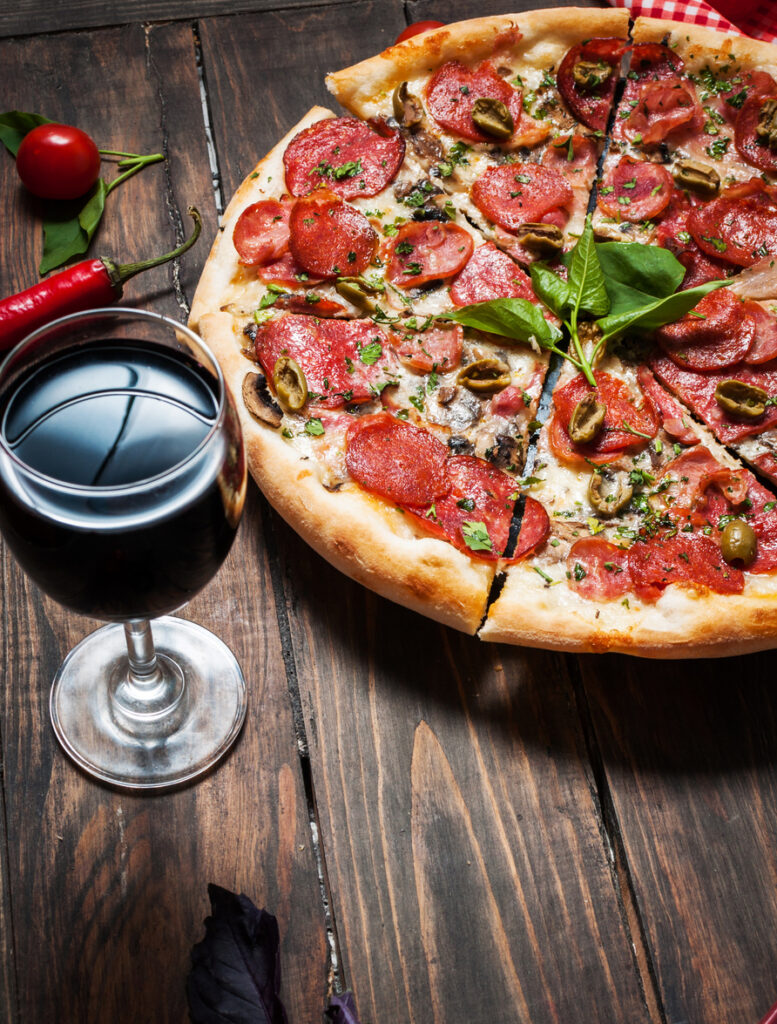 delicious pizza, glass of wine vegetables and spices
