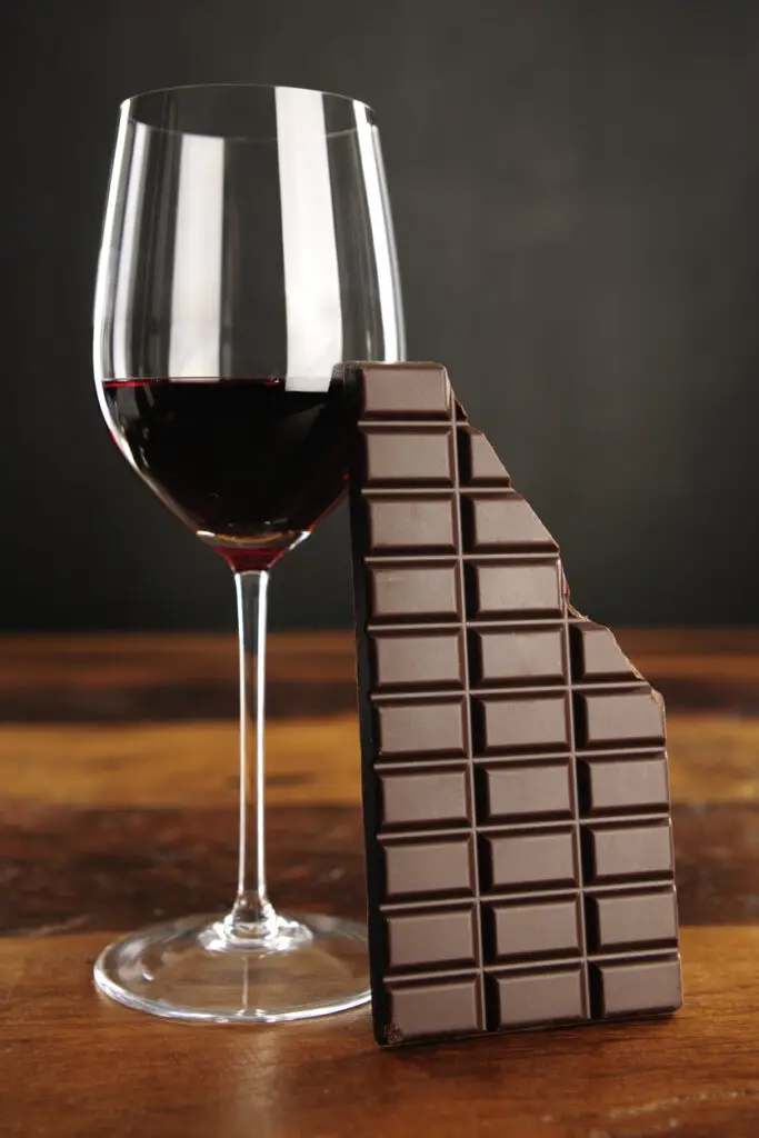 Glass of red wine and chocolate bar