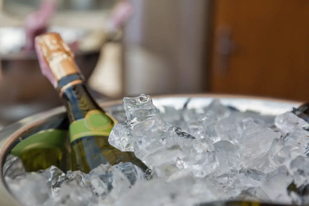 Sparkling wine bottle in ice bucket