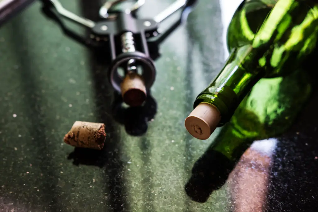 Cracked wine cork while opened, on black concrete stone, selective focus