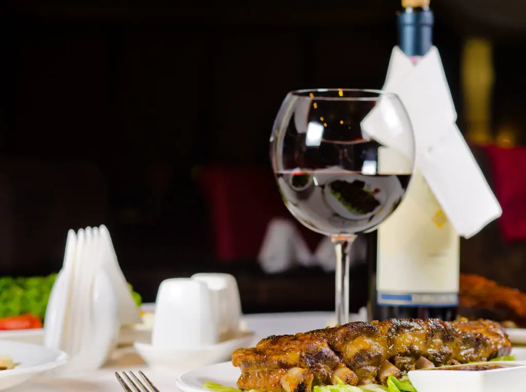 Glass of Wine Served with Ribs in Restaurant