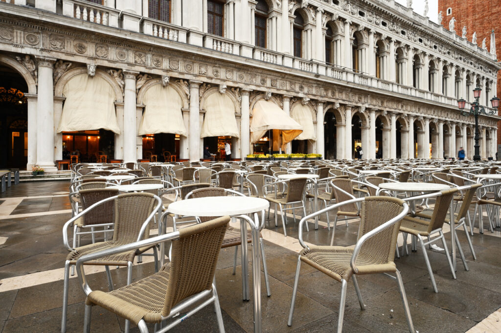 Empty tables in front of a cafe in Venice, Italy