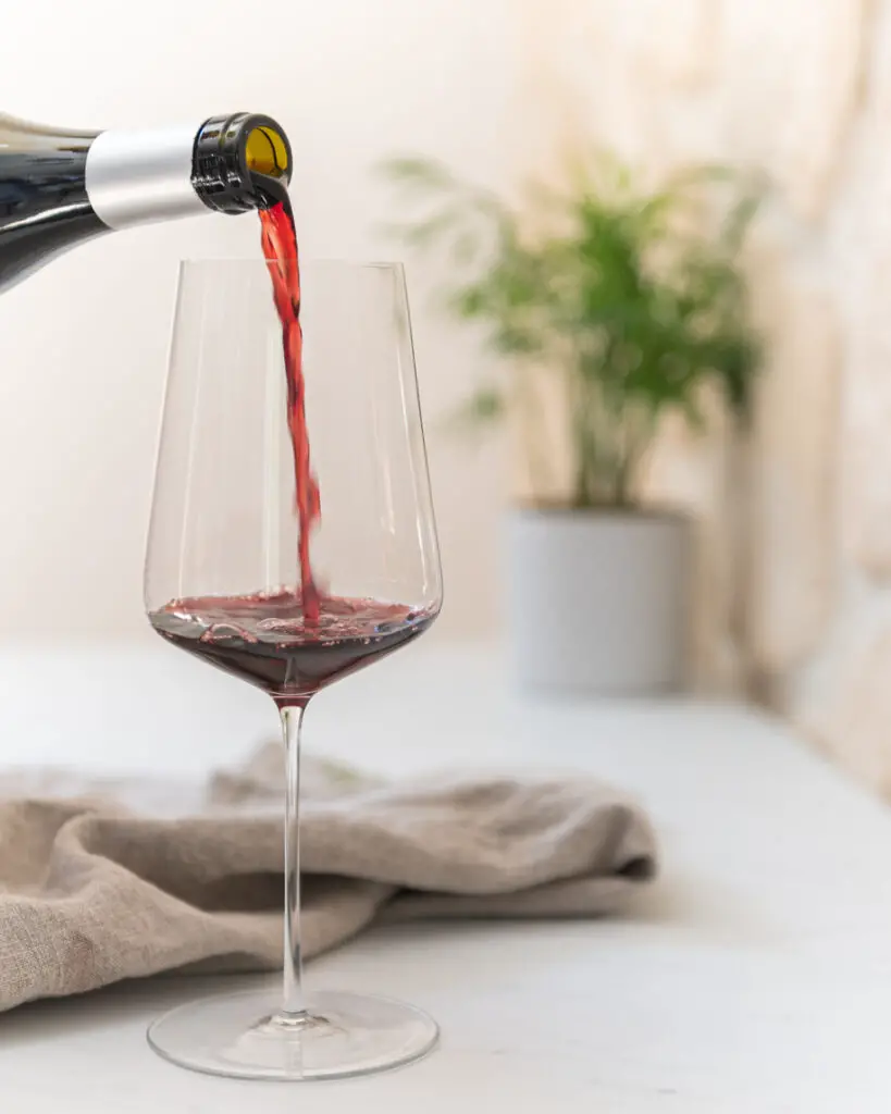 Pouring red wine on a marble counter