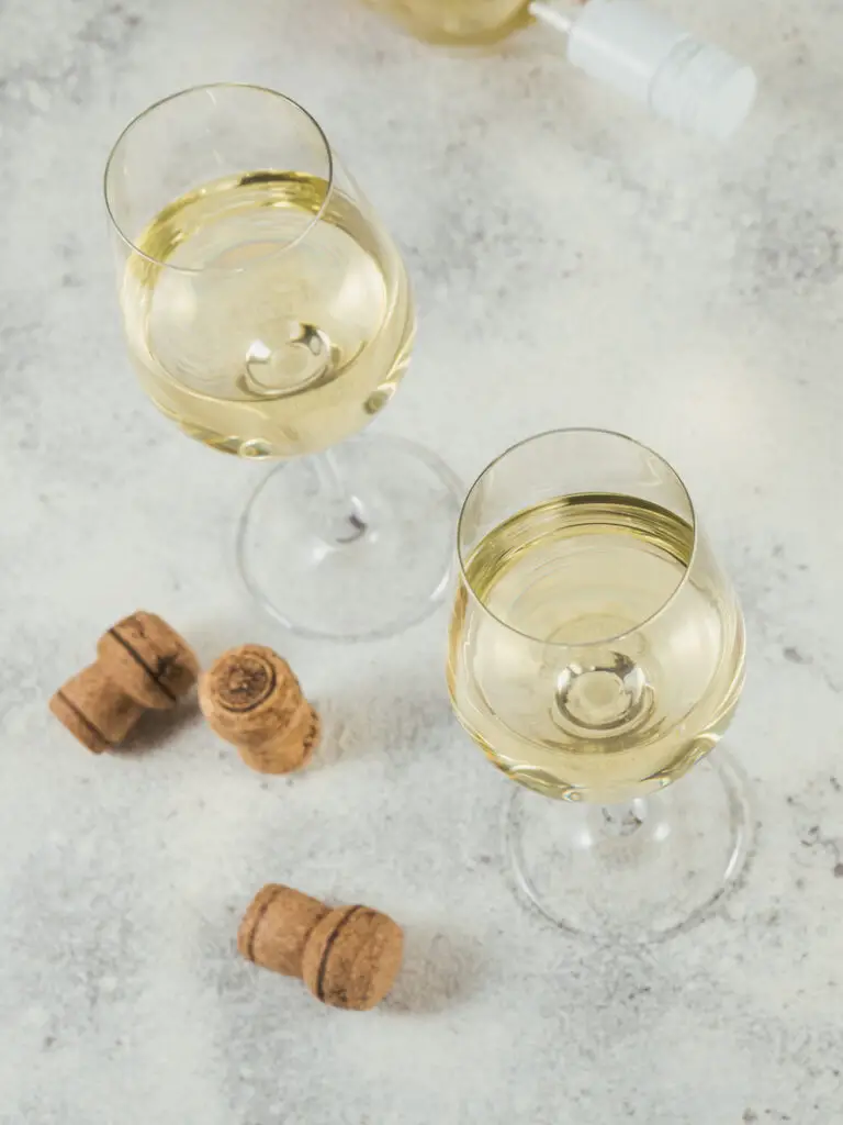 Two glasses of white wine  on light background. Wine mood concept