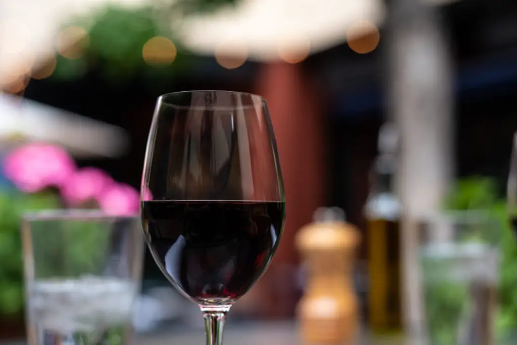 glass of red wine on table on romantic dinner date